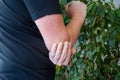 Pain in elbow concept photo. Person holds with palm of other hand over area of Ã¢â¬â¹Ã¢â¬â¹elbow due to occurrence of severe pain Royalty Free Stock Photo